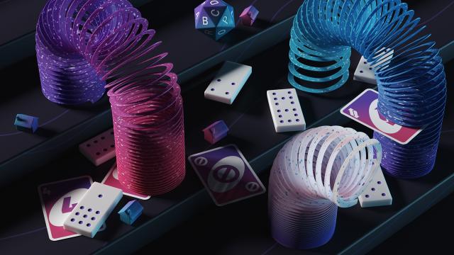 Three slinkies travel down a set of stairs with board game elements strewn everywhere
